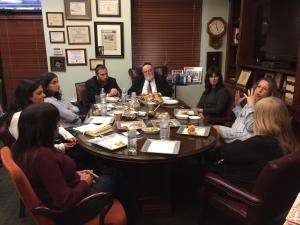 Visitors gather around for discussion at Shema Kolainu, School for children with Autism