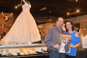 The Irvine's at the 2018 Orange County Fair in Costa Mesa, California standing in front of a exhibit that featured their wedding